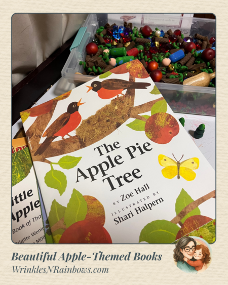 The apple picture book "The Apple Pie Tree" rests against an apple themed sensory bin.